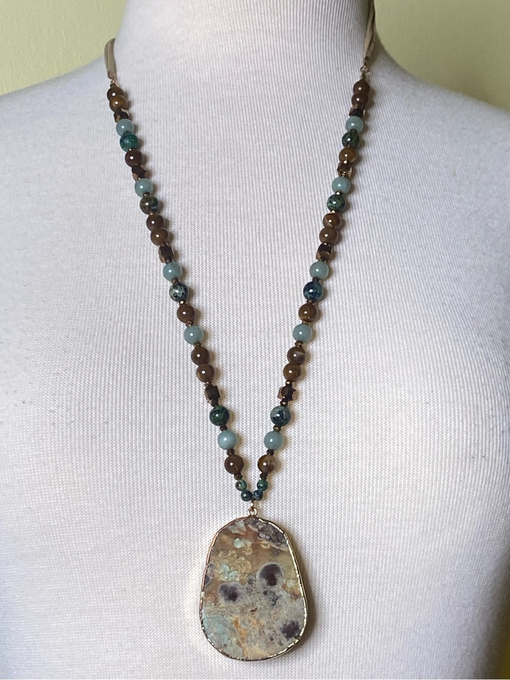 Beautiful teal and tan stone necklace on Tan Suede Necklace.